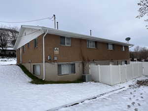 Snow covered property with central AC