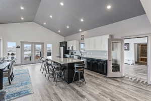 Kitchen with a center island, granite counter tops, french doors leading to deck, stainless steel appliances and 10' ceilings.