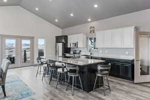 Kitchen with a center island, granite counter tops, french doors leading to deck, stainless steel appliances and 10' ceilings.