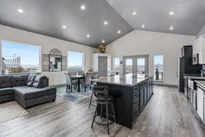 Kitchen with a center island, granite counter tops, french doors leading to deck, stainless steel appliances and 10' ceilings.