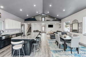 Kitchen with a center island, granite counter tops, door leading to deck, stainless steel appliances and 10' ceilings.