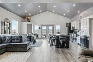 Kitchen with a center island, granite counter tops, french doors leading to deck, stainless steel appliances and 10' ceilings.