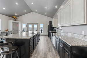 Kitchen with a center island, granite counter tops, french doors leading to deck, stainless steel appliances and 10' ceilings.