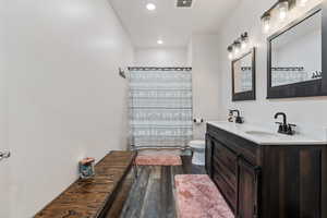 Basement Restroom featuring dual vanity, tub and shower.