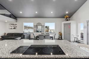 Kitchen with a center island, granite counter tops, french doors leading to deck, stainless steel appliances and 10' ceilings.