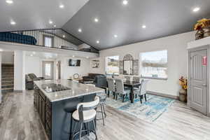 Kitchen with a center island, granite counter tops, door leading to deck, stainless steel appliances and 10' ceilings.