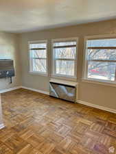 Empty room with light parquet flooring