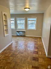 Spare room featuring parquet floors