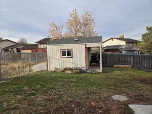 View of outdoor structure with a lawn