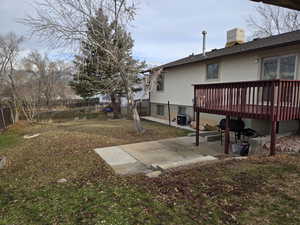 View of yard featuring a patio area and a wooden deck