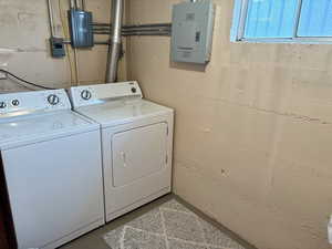 Washroom with electric panel and washer and dryer