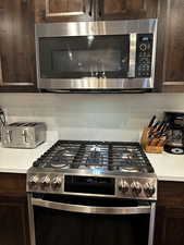 Kitchen featuring dark brown cabinets and stainless steel appliances