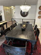 Dining room featuring a chandelier and wood-type flooring