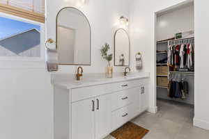 Bathroom featuring tile patterned floors, plenty of natural light, and vanity