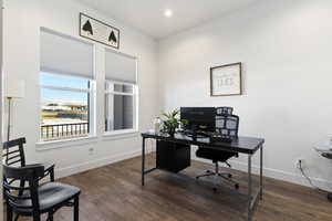 Office area with dark hardwood / wood-style floors