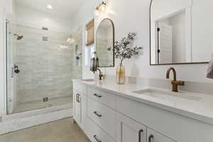 Bathroom with tile patterned floors, vanity, and a shower with shower door