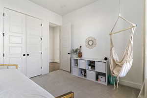 Carpeted bedroom with a closet