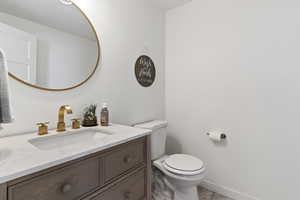 Bathroom with tile patterned flooring, vanity, and toilet