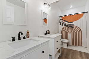 Bathroom featuring vanity and wood-type flooring