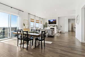 Dining room with hardwood / wood-style floors and a healthy amount of sunlight