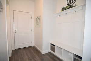 Mudroom featuring bench and coat hook area with access to garage