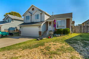 View of front of house with a garage and a front lawn