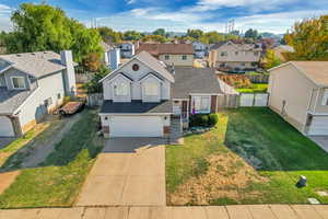 View of front of home with a garage and a front lawn