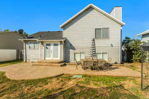 Back of property with french doors and a patio