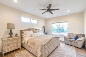 Bedroom with ceiling fan and light wood-type flooring