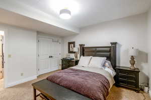 Carpeted bedroom with a closet