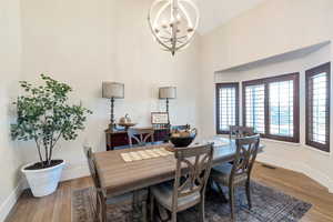 Dining area featuring hardwood / wood-style floors and a notable chandelier