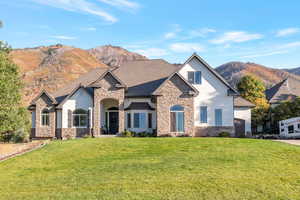 View of front facade with a mountain view and a front yard