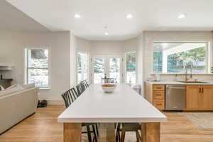 Kitchen featuring dishwasher, light hardwood / wood-style floors, a wealth of natural light, and sink