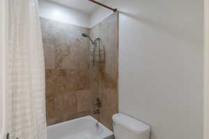 Bathroom with shower / tub combo with curtain