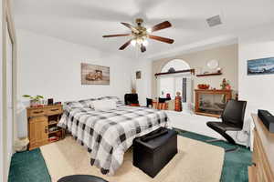 Carpeted bedroom with ceiling fan