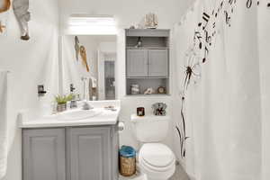 Bathroom featuring tile patterned flooring, vanity, and toilet