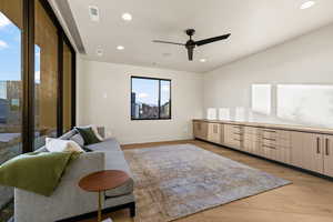 Sitting room featuring ceiling fan and light hardwood / wood-style flooring