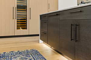 Detailed view of wood finished floors and wine cooler