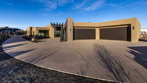 Pueblo-style house with a garage