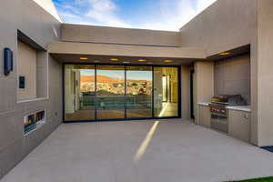 View of patio / terrace with a mountain view, a grill, and a tiled fireplace