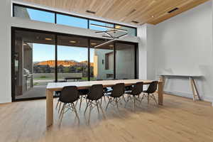 Dining room with wood ceiling, light wood-type flooring, and a mountain view