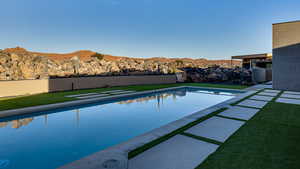 View of swimming pool featuring a mountain view and a yard