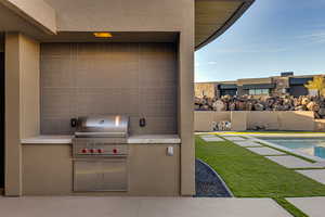 View of patio featuring a grill and exterior kitchen