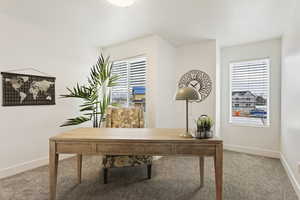 Office area with carpet flooring and plenty of natural light