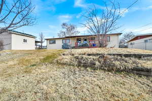 Single story home featuring a front lawn