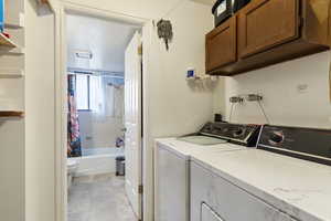 Laundry room featuring cabinets and independent washer and dryer