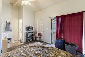 Bedroom with ceiling fan, beam ceiling, high vaulted ceiling, and dark carpet