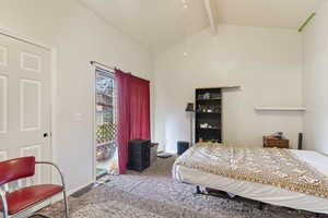 Bedroom featuring lofted ceiling with beams