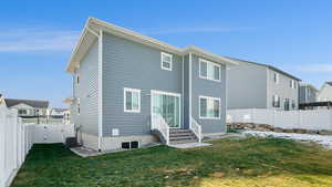 Rear view of property featuring a yard