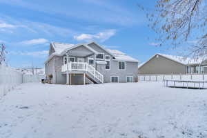 Snow covered property featuring a trampoline